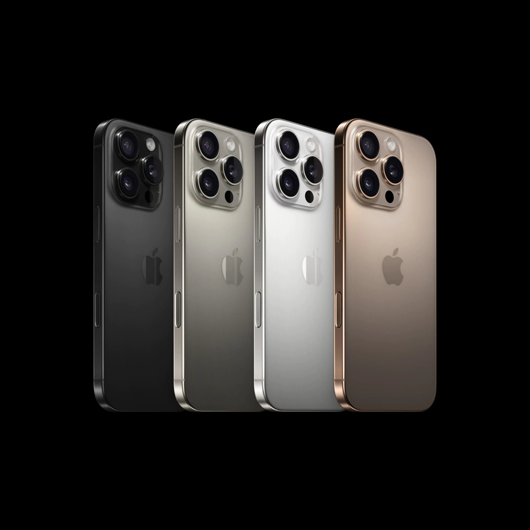 Fire iPhone 16 Pro Max-telefoner vist bagfra i forskellige farver med tredobbelt kamerasystem på sort baggrund.
