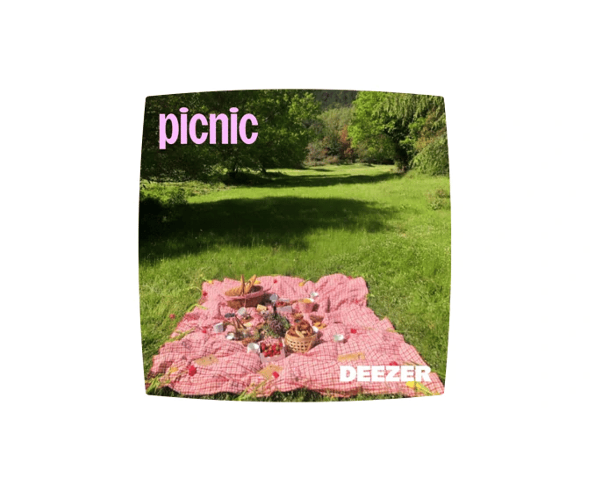 Picnic-tæppe med mad og blomster i en grøn park med Deezer- og picnic-tekst.